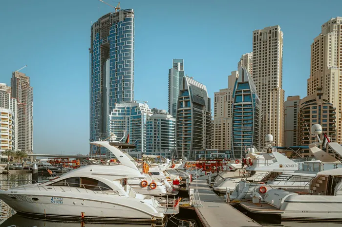 Yachts moored beneath Dubai Marina towers